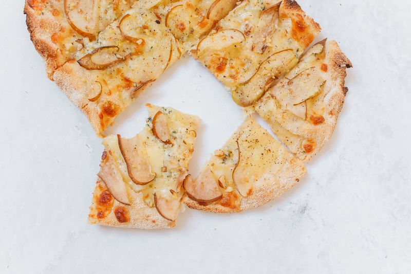 Delicious pizza slice served at Apache Pizza